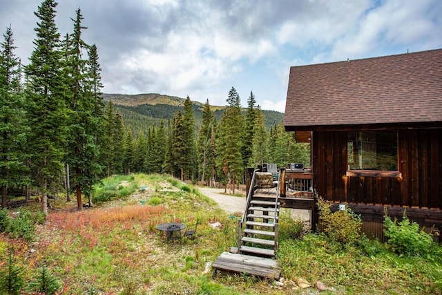 view of yard featuring a deck with mountain view