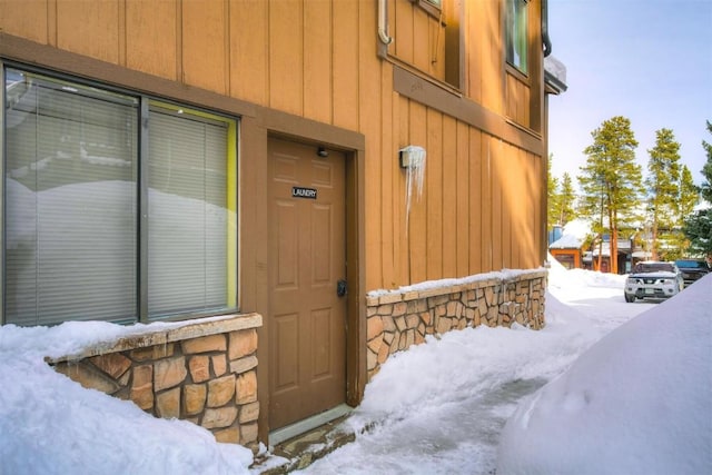 view of snow covered property entrance