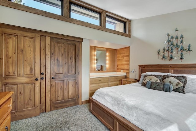 bedroom featuring light colored carpet and a towering ceiling