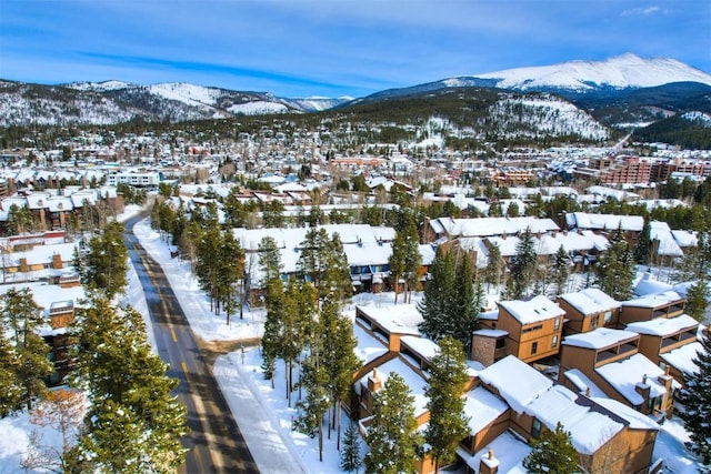 snowy aerial view with a residential view and a mountain view