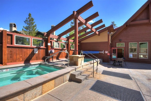 view of swimming pool with an in ground hot tub, a patio, and a pergola