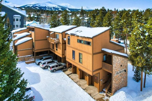 snow covered building with a mountain view