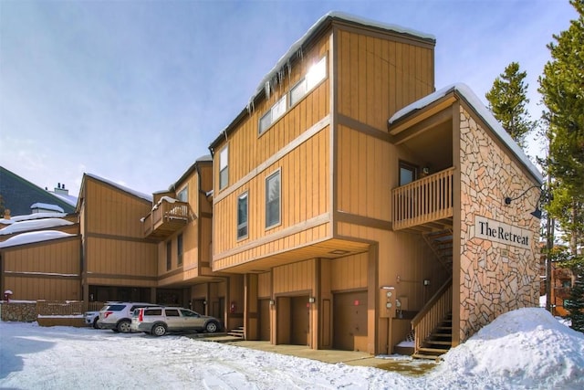 snow covered building featuring a garage