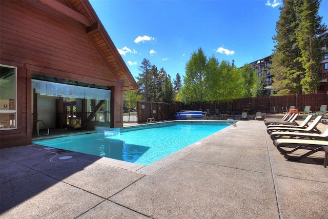 view of pool featuring a patio area, fence, and a fenced in pool