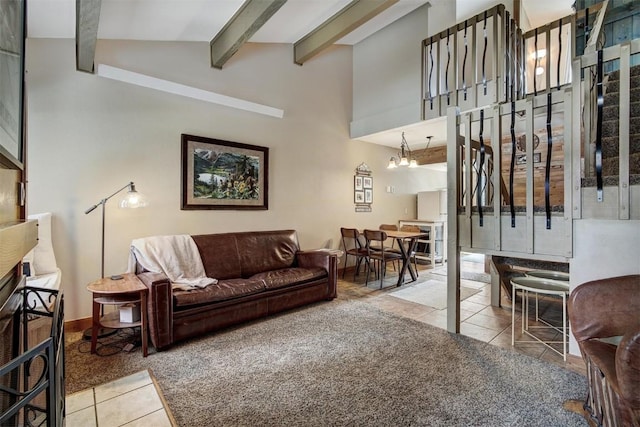 tiled living area featuring baseboards, a chandelier, stairs, high vaulted ceiling, and beam ceiling