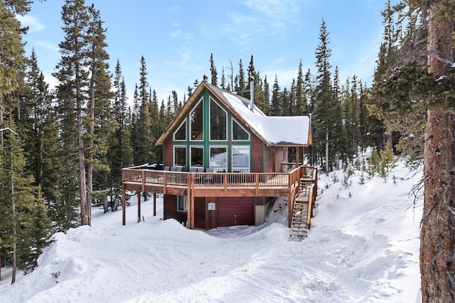 snow covered property featuring a wooden deck