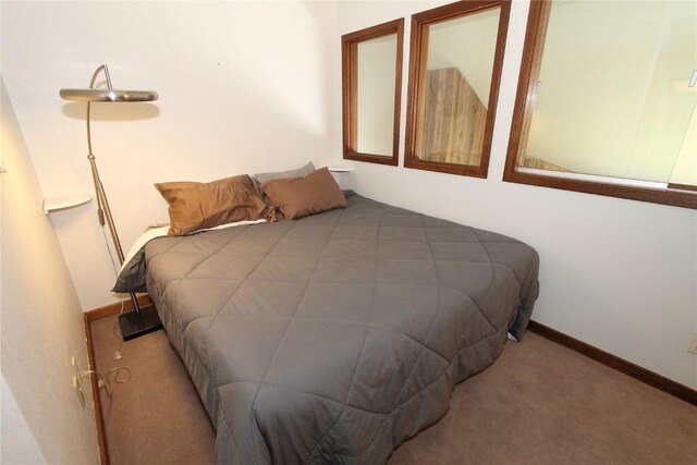 carpeted bedroom with baseboards