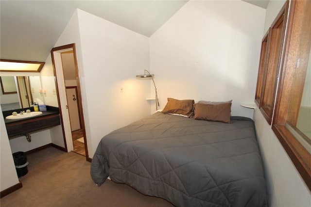 carpeted bedroom featuring vaulted ceiling and baseboards