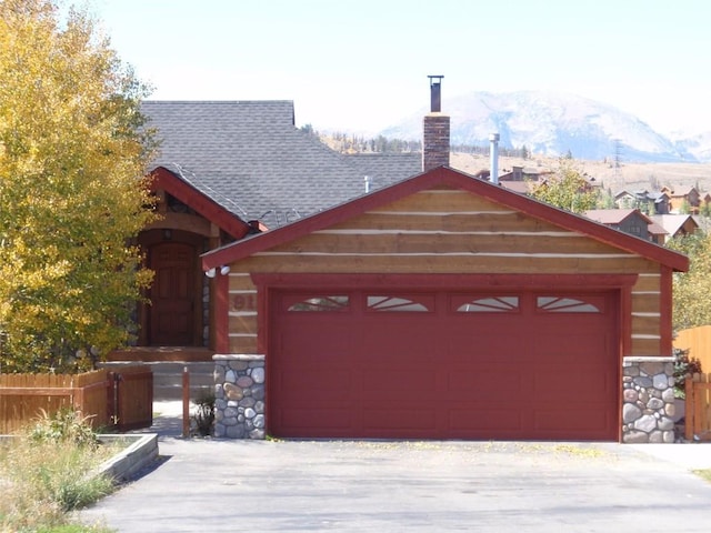 view of front facade with a mountain view and a garage