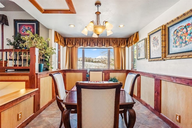 dining space with a chandelier and light tile patterned floors