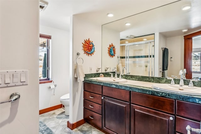 bathroom with tile patterned flooring, vanity, toilet, and walk in shower