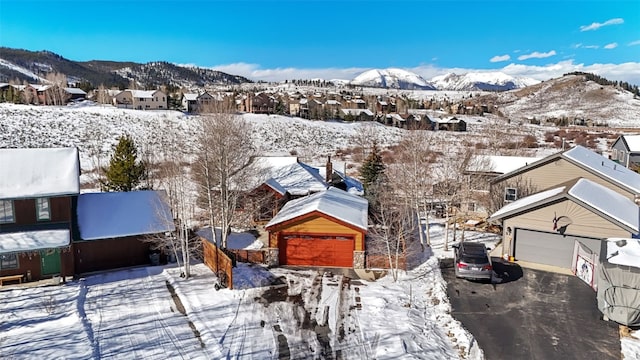 snowy aerial view featuring a mountain view