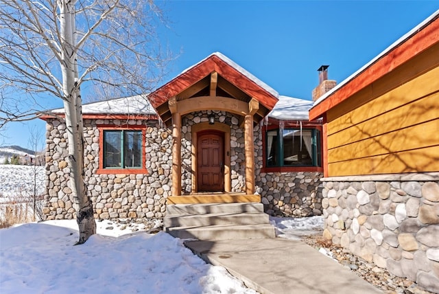 view of snow covered property entrance