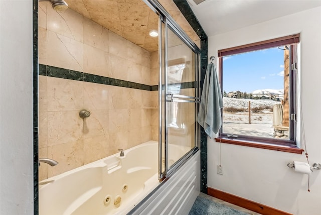 bathroom with shower / bath combination with glass door