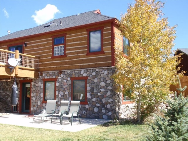 back of property featuring a balcony and a patio