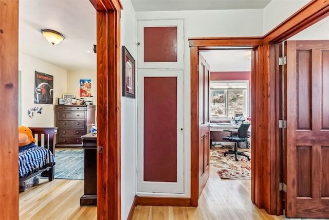 corridor with light hardwood / wood-style flooring