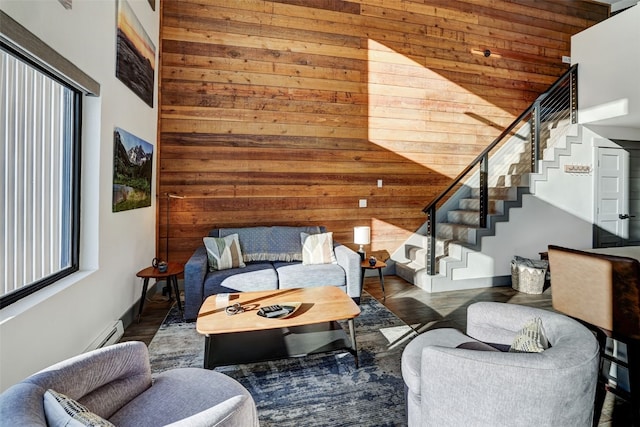 living room with high vaulted ceiling and wood walls