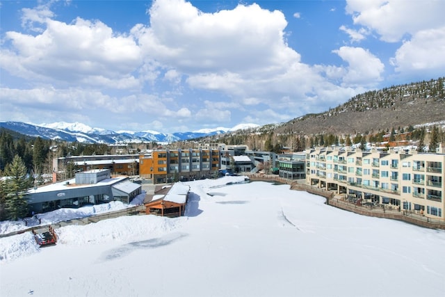 snowy aerial view with a mountain view