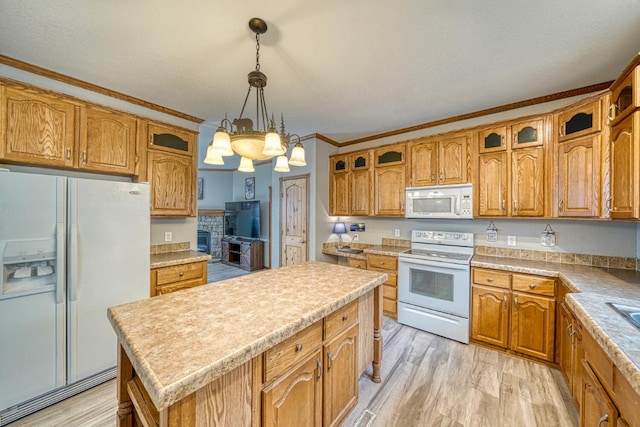 kitchen featuring glass insert cabinets, white appliances, and brown cabinets