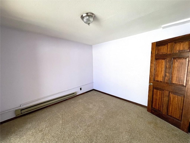 carpeted empty room featuring a baseboard radiator