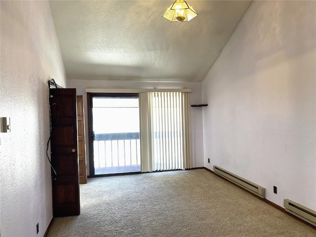 unfurnished room with baseboard heating, carpet, and lofted ceiling