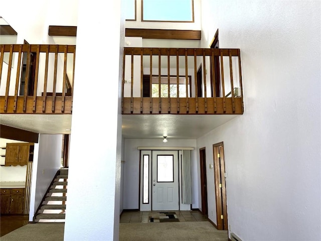 staircase featuring a wealth of natural light and tile patterned flooring