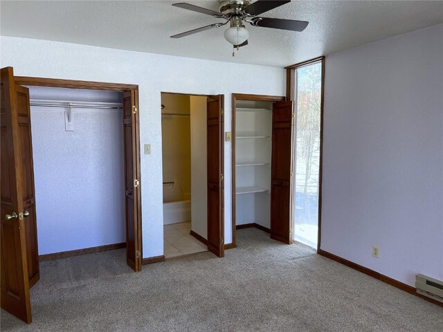 unfurnished bedroom with a textured ceiling, ceiling fan, light carpet, and a baseboard radiator