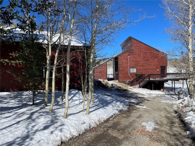 view of snowy exterior featuring a deck