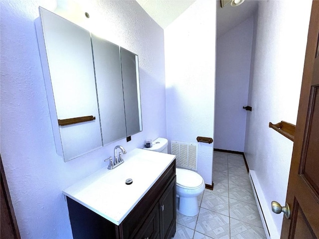 bathroom featuring vanity, toilet, and a baseboard heating unit