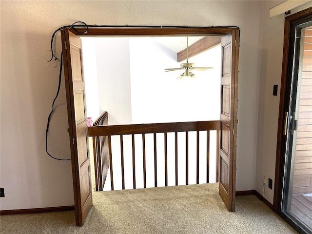 doorway with carpet flooring and ceiling fan