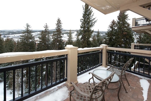 view of snow covered back of property