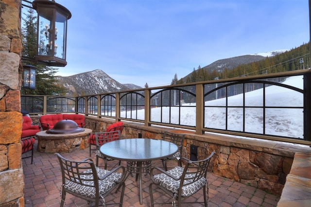 snow covered patio featuring a mountain view