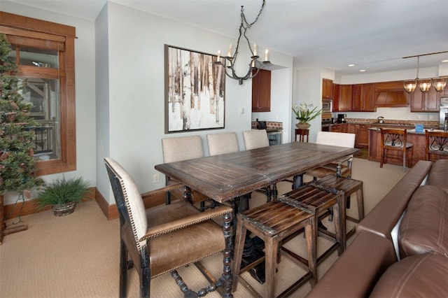 carpeted dining room featuring an inviting chandelier