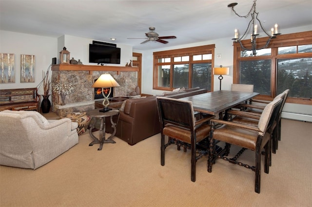 carpeted dining space with ceiling fan with notable chandelier