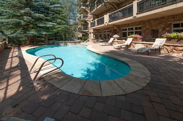 view of swimming pool featuring a patio area