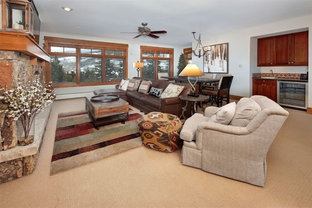 living room with sink, carpet flooring, a healthy amount of sunlight, and wine cooler