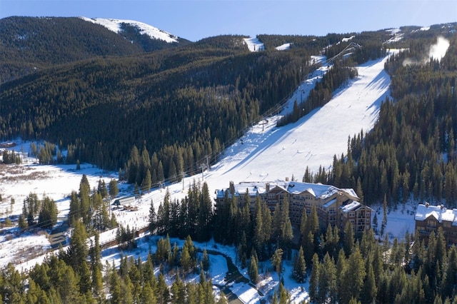 snowy aerial view featuring a mountain view