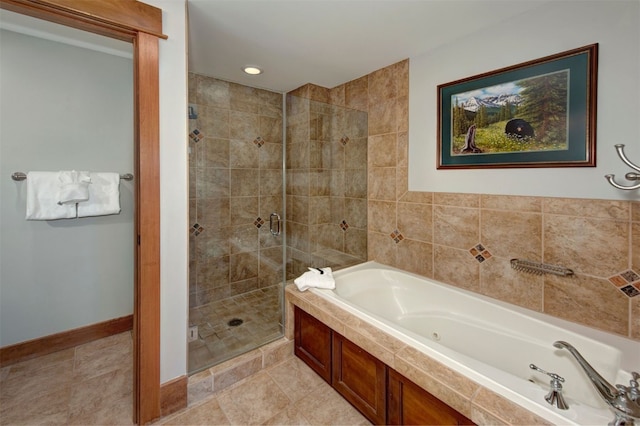 bathroom with tile patterned flooring and separate shower and tub