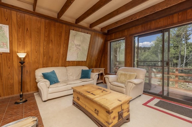 living room with beamed ceiling and wooden walls