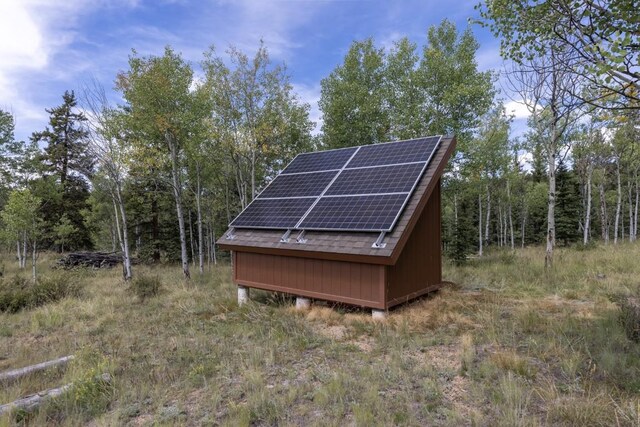 view of outbuilding with solar panels