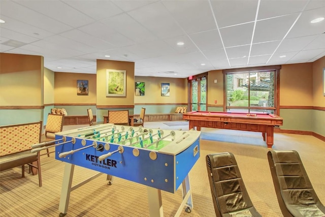 game room with a paneled ceiling, a wainscoted wall, light colored carpet, and recessed lighting