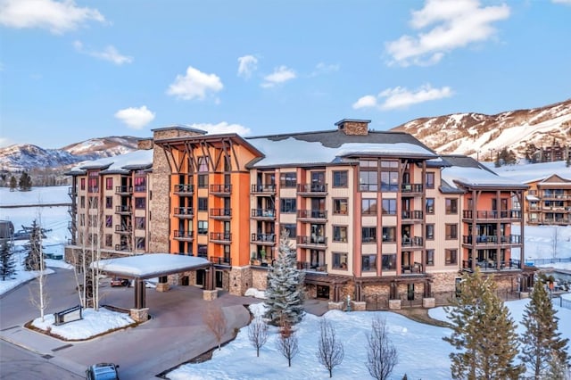 snow covered property with a mountain view