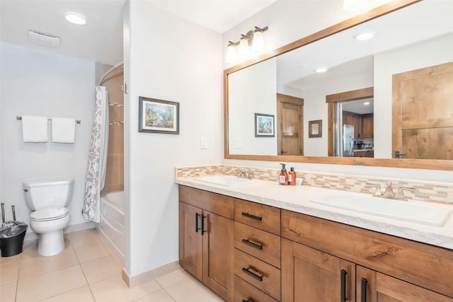 bathroom with toilet, tile patterned flooring, backsplash, and a sink