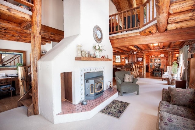 living area featuring a high ceiling, a wood stove, wooden ceiling, beamed ceiling, and rustic walls