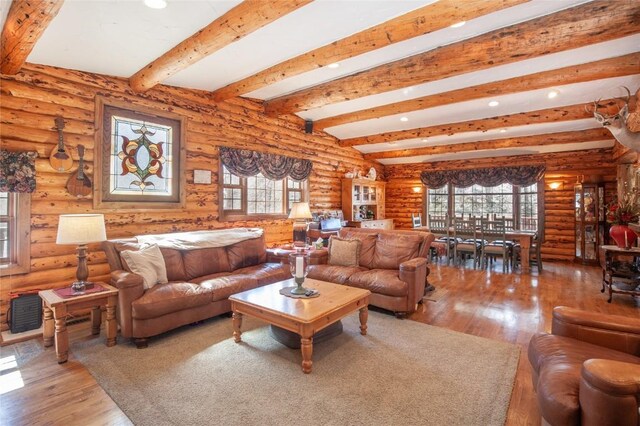 living area featuring beam ceiling, ceiling fan, high vaulted ceiling, light carpet, and wood ceiling