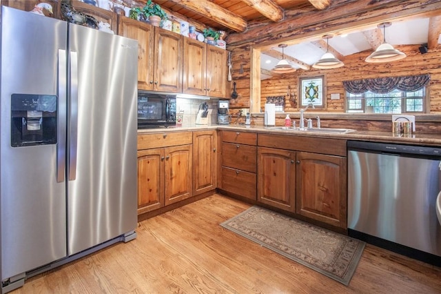 kitchen featuring brown cabinetry, a sink, stainless steel appliances, wooden ceiling, and light wood-type flooring