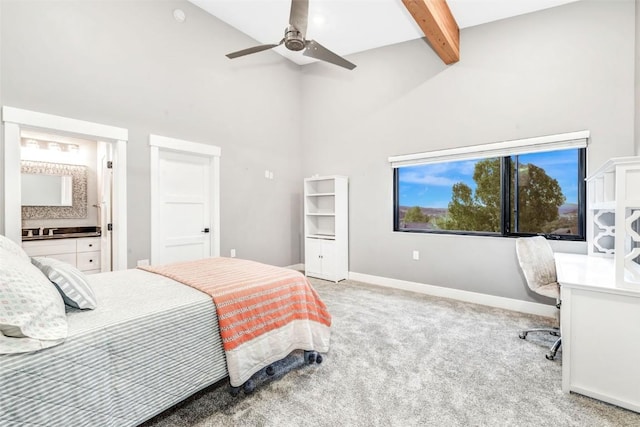 bedroom with ensuite bath, ceiling fan, light carpet, and lofted ceiling with beams