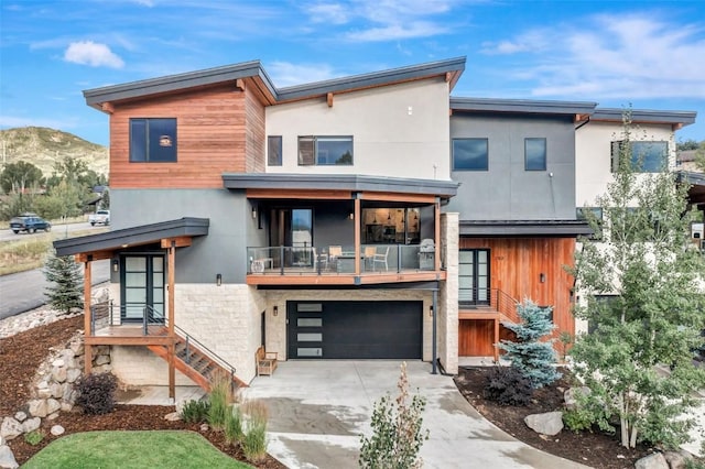 contemporary house featuring a mountain view and a garage