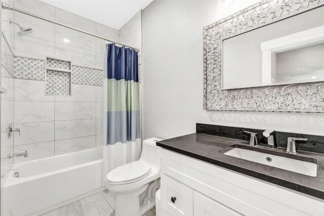 full bathroom featuring vanity, toilet, and shower / bathtub combination with curtain