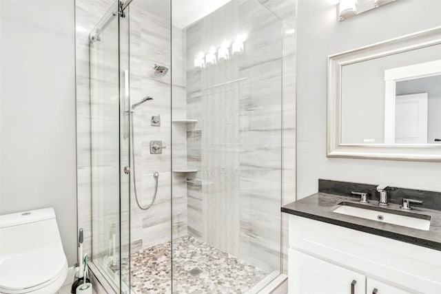 bathroom featuring vanity, toilet, and walk in shower